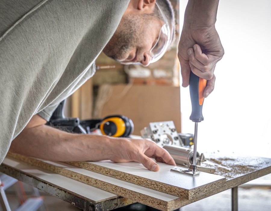 screwing-self-tapping-screw-into-metal-fastening-hole-wood-strip-using-screwdriver-work-carpenter_169016-13177