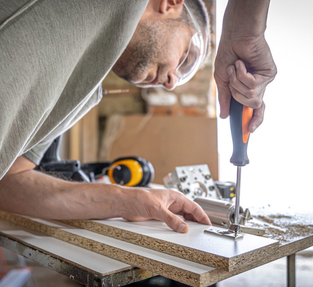 screwing-self-tapping-screw-into-metal-fastening-hole-wood-strip-using-screwdriver-work-carpenter_169016-13177